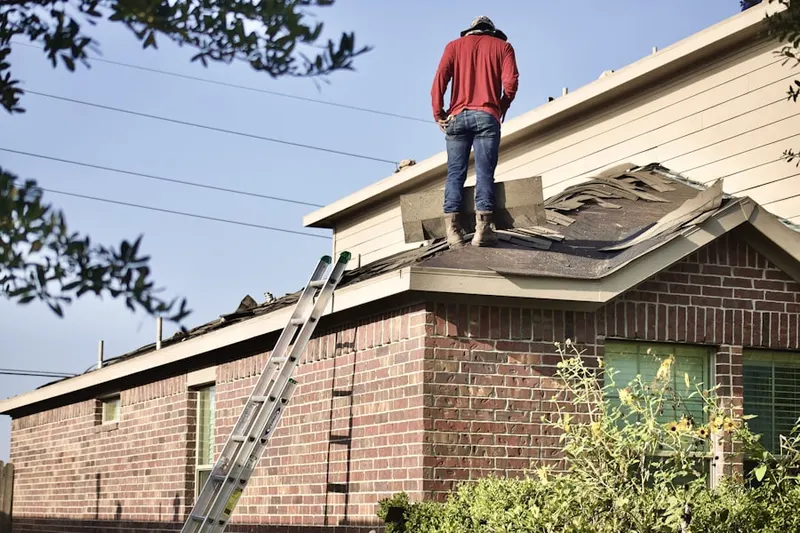 Professional roofer working on a residential roof in North Hills
